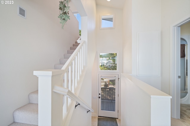 stairs featuring a high ceiling