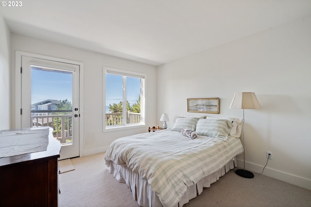 bedroom with light carpet and access to outside