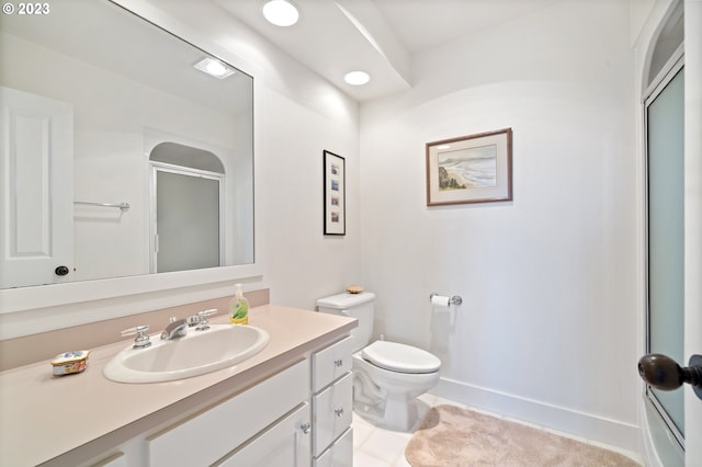 bathroom with tile patterned flooring, toilet, vanity, and walk in shower