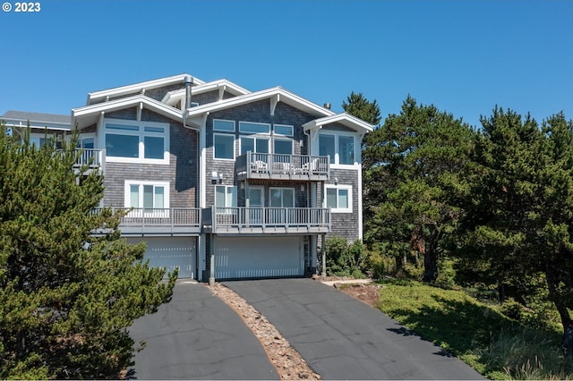 view of front facade with a garage and a balcony