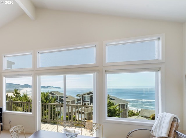 doorway to outside featuring vaulted ceiling with beams and a water view