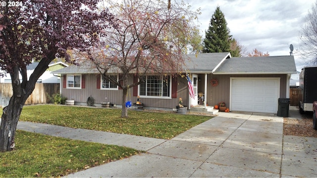 ranch-style home with a garage and a front yard