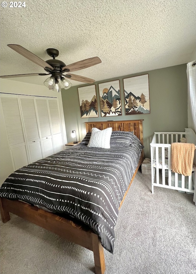 carpeted bedroom featuring a textured ceiling, ceiling fan, and a closet