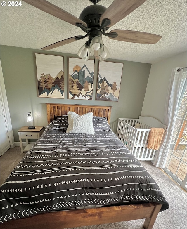 carpeted bedroom with a textured ceiling and ceiling fan