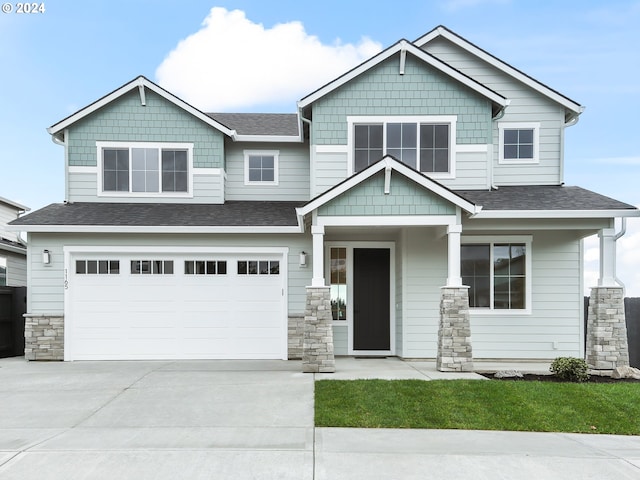 craftsman-style house featuring covered porch and a garage