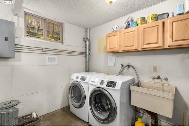 washroom featuring cabinets, sink, electric panel, and washer and clothes dryer