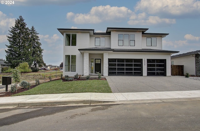 view of front of home featuring a garage and a front yard