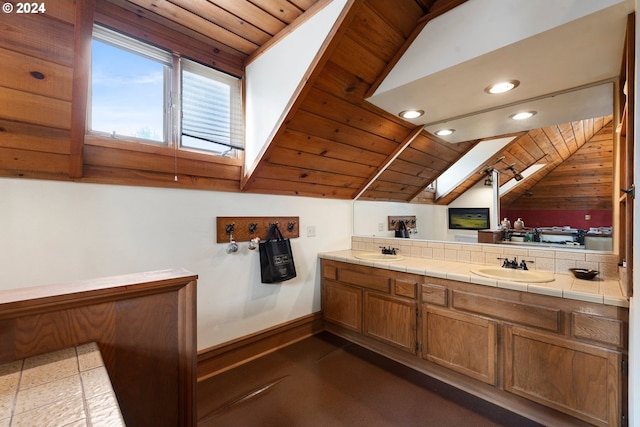 bathroom featuring wooden ceiling, vanity, and lofted ceiling with skylight