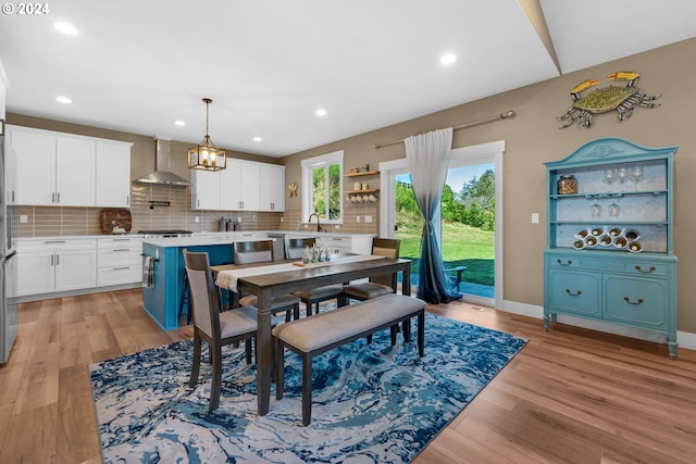 dining space with sink and light hardwood / wood-style floors