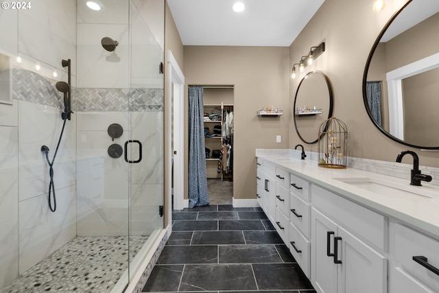 bathroom with vanity and a shower with shower door