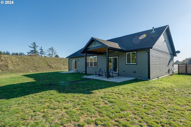 back of property featuring a yard and a patio