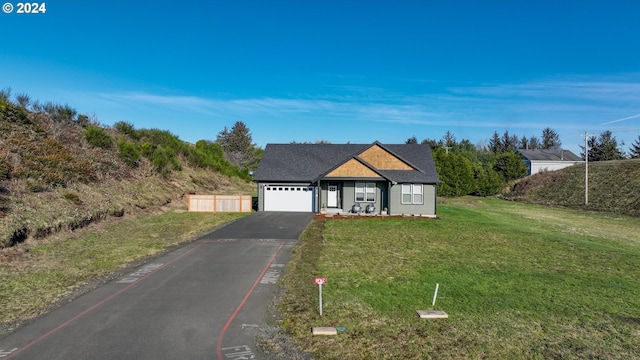 view of front facade featuring a garage and a front lawn