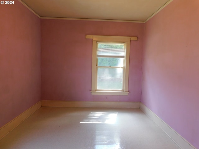 unfurnished room with crown molding