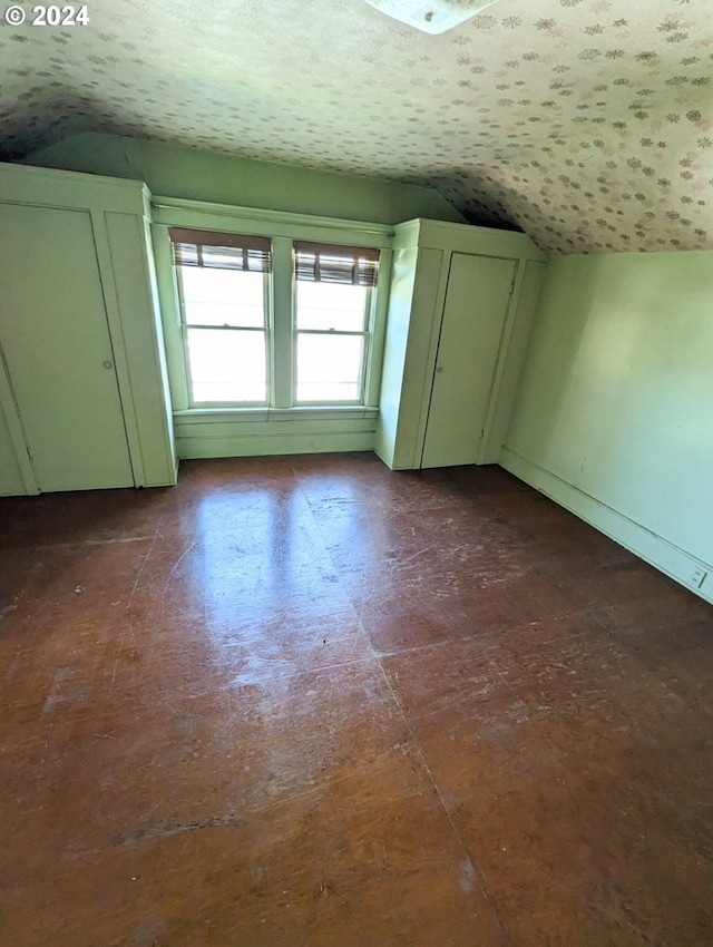 additional living space featuring vaulted ceiling