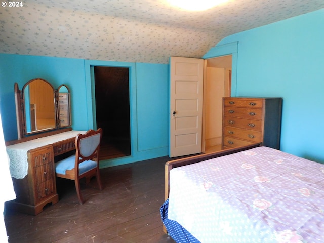 bedroom featuring lofted ceiling and dark wood-type flooring