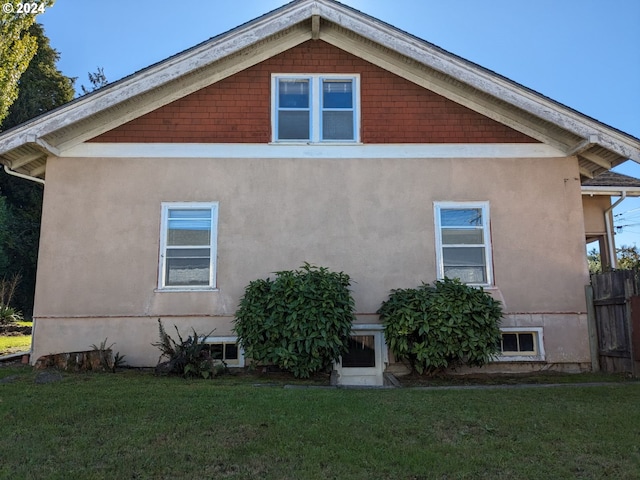 back of house with a lawn