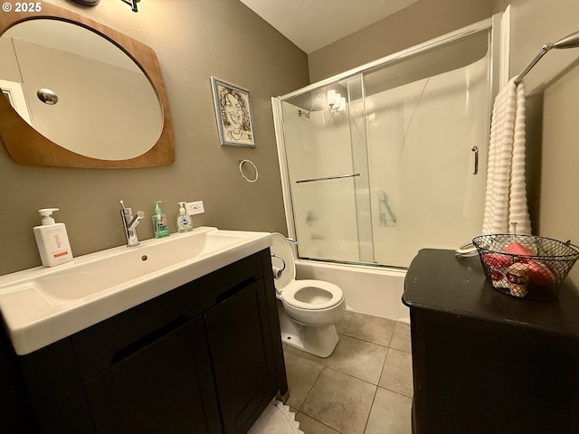 bathroom with vanity, shower / bath combination with glass door, toilet, and tile patterned flooring