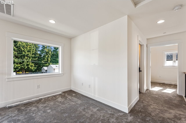 empty room featuring dark carpet