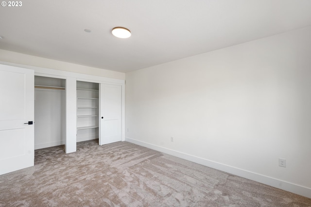 unfurnished bedroom featuring a closet and carpet flooring