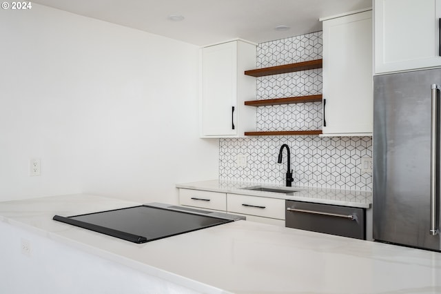 kitchen with white cabinetry, stainless steel appliances, and sink