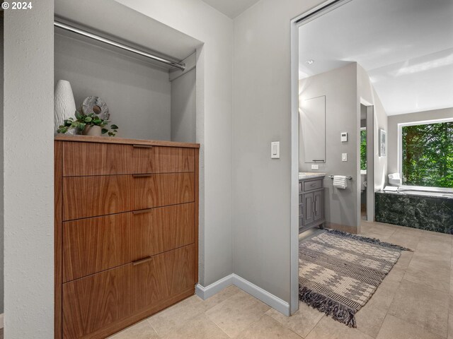 4731 SW 18th Dr, Portland, OR 97239 - bathroom with lofted ceiling, vanity, and a bathing tub