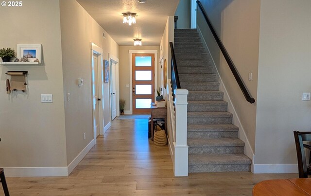 unfurnished living room with ceiling fan, sink, and light wood-type flooring