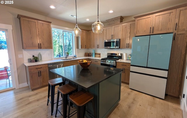 kitchen featuring a kitchen island, light wood-type flooring, pendant lighting, and ceiling fan