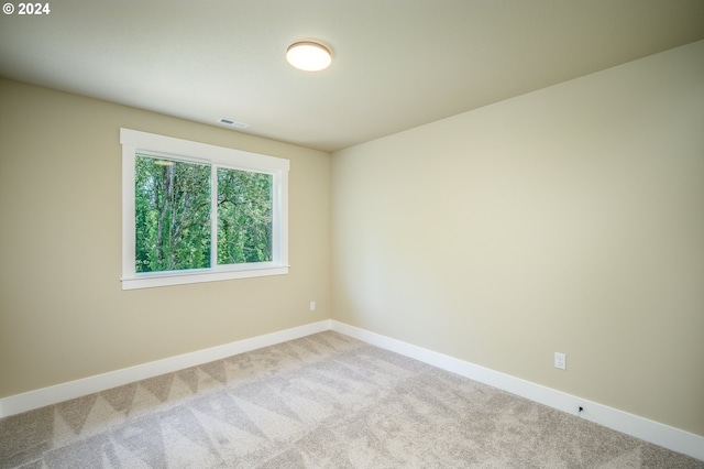 unfurnished bedroom featuring light carpet