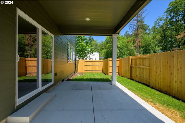 view of property exterior with a patio area and a yard