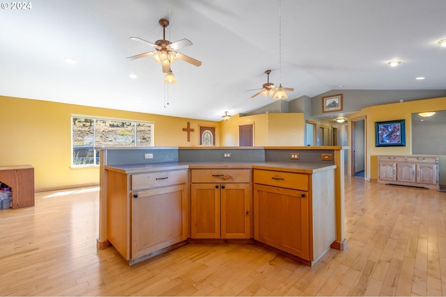 6997 SE Scenic Dr, Prineville, OR 97754 - kitchen featuring light wood-style flooring, a center island, a ceiling fan, and lofted ceiling