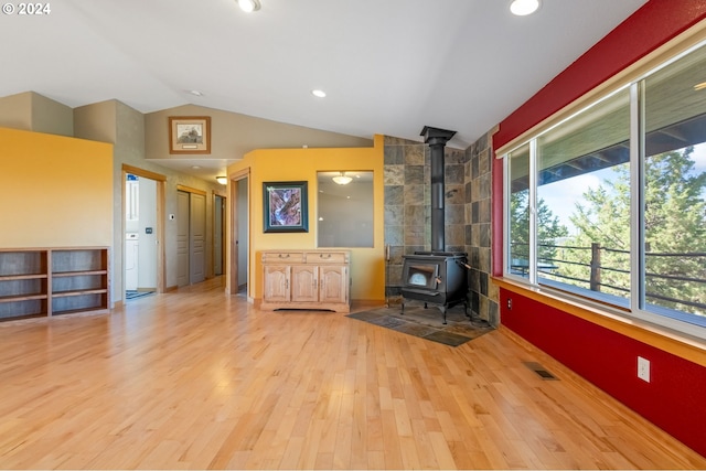 6997 SE Scenic Dr, Prineville, OR 97754 - unfurnished living room with visible vents, a wood stove, recessed lighting, wood finished floors, and vaulted ceiling