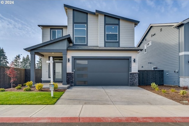 view of front of home with a garage and a front lawn