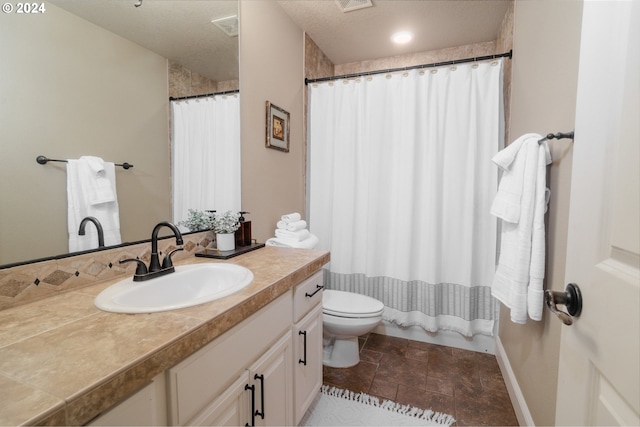 bathroom with vanity, a textured ceiling, curtained shower, and toilet