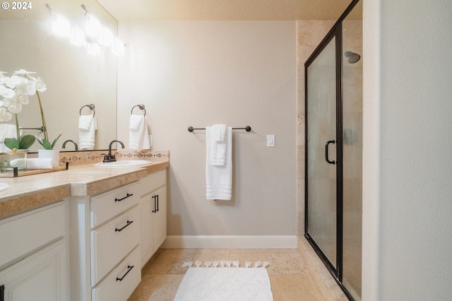 bathroom featuring vanity, tile patterned floors, and a shower with door