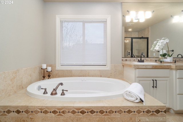 bathroom with vanity and separate shower and tub