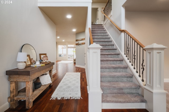 stairway with hardwood / wood-style flooring