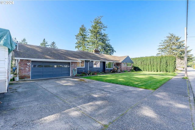 ranch-style house featuring a garage and a front yard