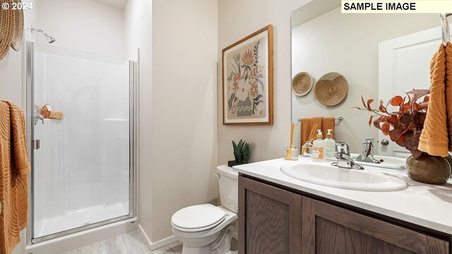 full bath featuring a shower stall, toilet, and vanity