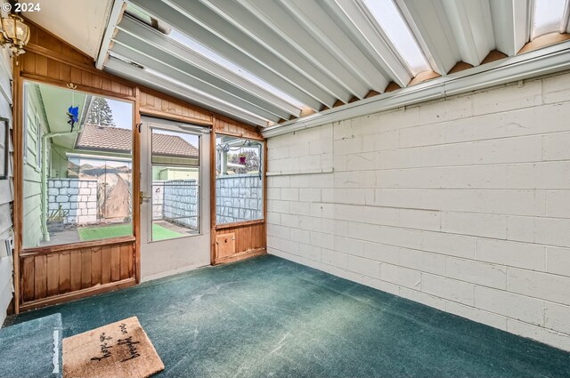 unfurnished sunroom with lofted ceiling