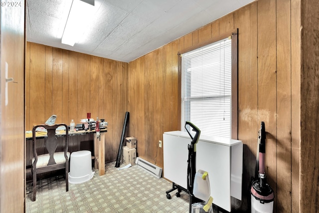 office with wooden walls and a baseboard heating unit