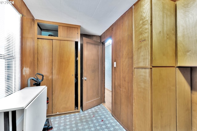 interior space with light floors and wooden walls