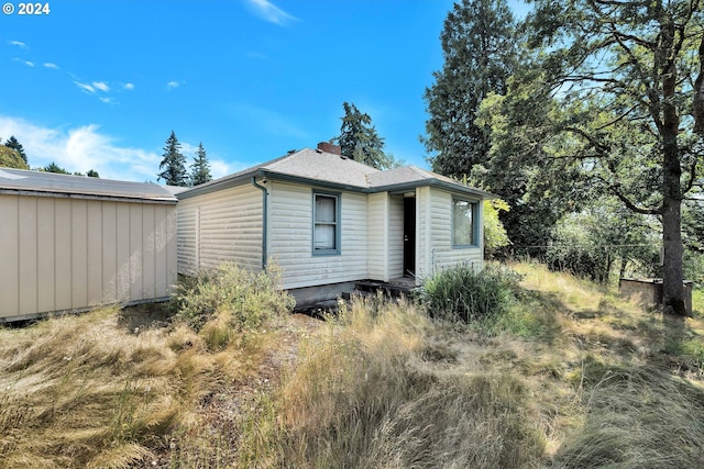 back of property featuring a chimney