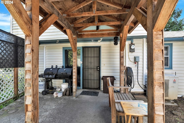 view of exterior entry featuring cooling unit and fence