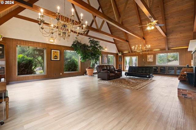 unfurnished living room featuring high vaulted ceiling, ceiling fan with notable chandelier, beam ceiling, and light hardwood / wood-style flooring