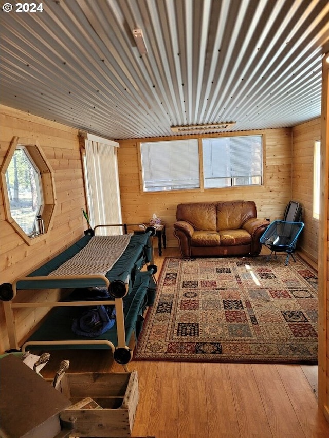 living room with wood walls and light hardwood / wood-style flooring