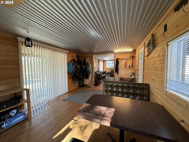 dining area featuring wooden walls and light hardwood / wood-style floors