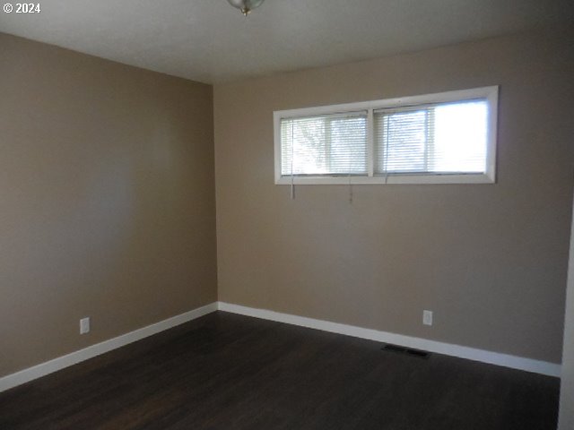 spare room featuring dark hardwood / wood-style flooring