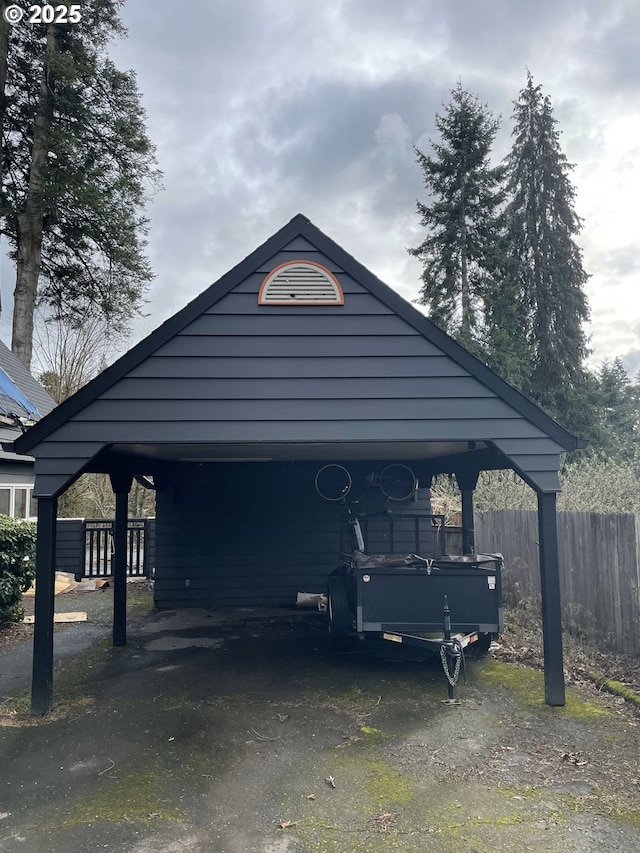 exterior space with fence and a carport