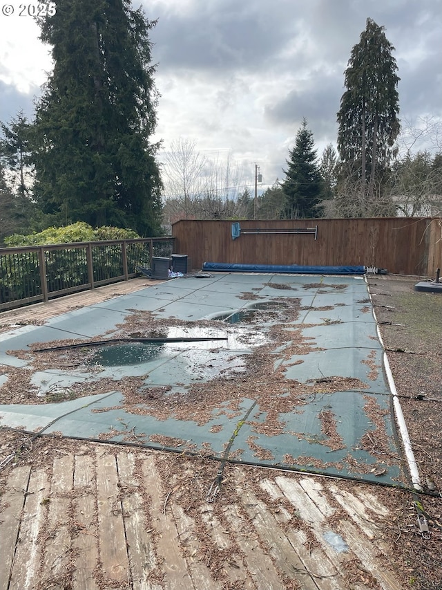 view of swimming pool featuring fence