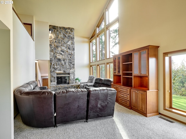 carpeted living room featuring high vaulted ceiling and a fireplace